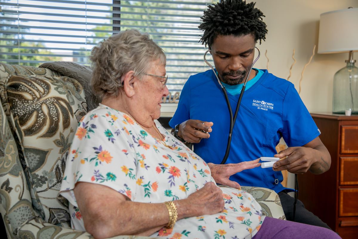 CNA checking pulse ox level for Assisted Living resident