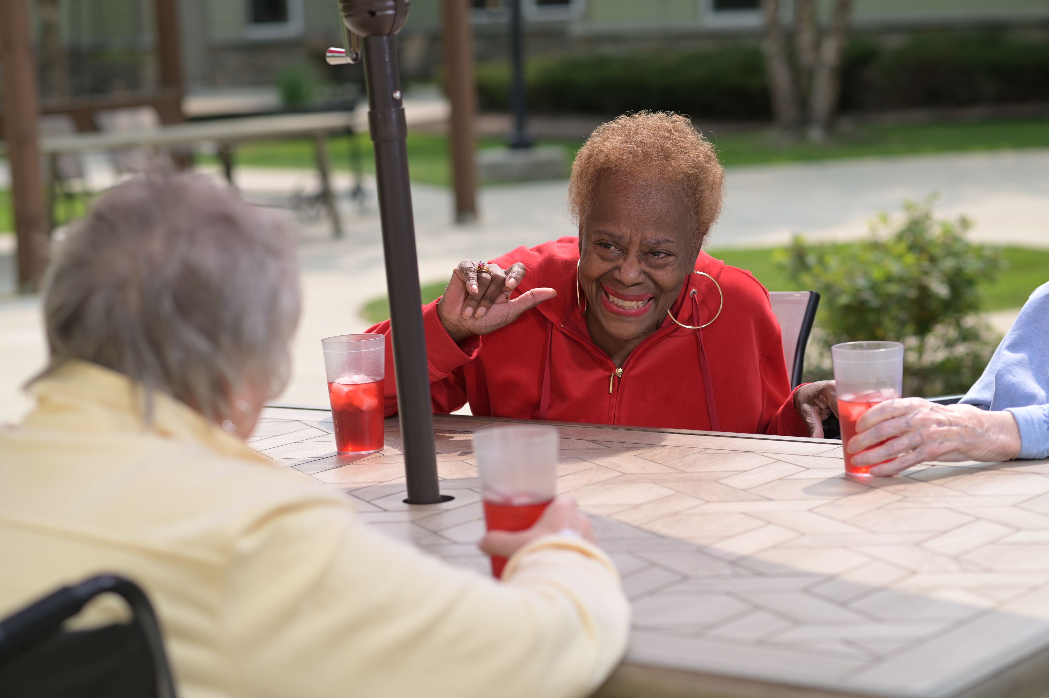ladies sitting on the patio enjoying conversation and beverages