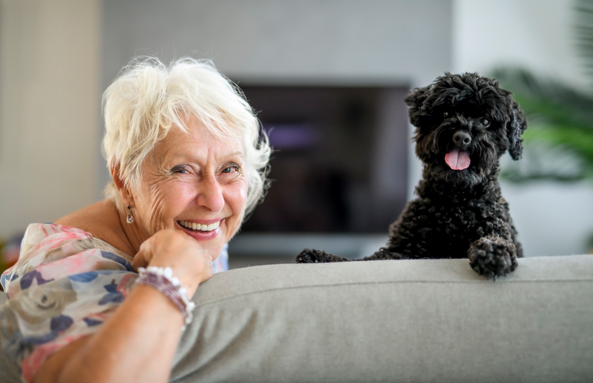 senior female on couch with dog