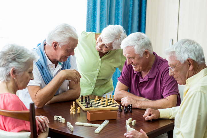 group of older adults playing chess